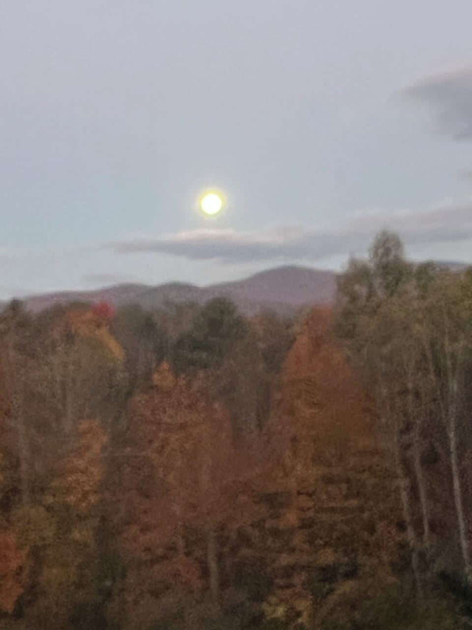 Fall full moon setting over the mountains, view from house