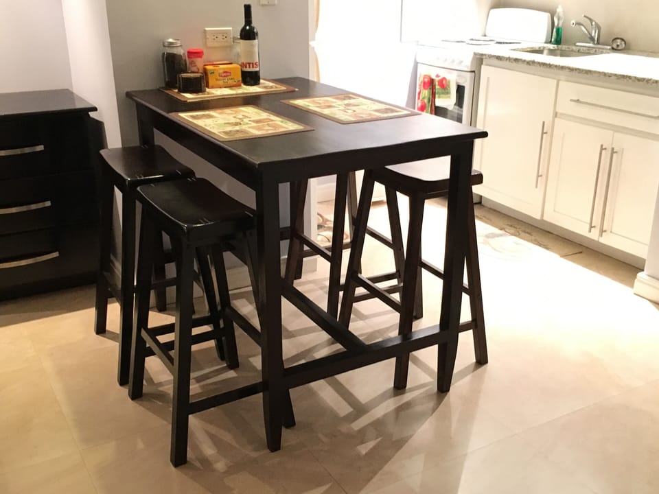 Dining table with four stools. 