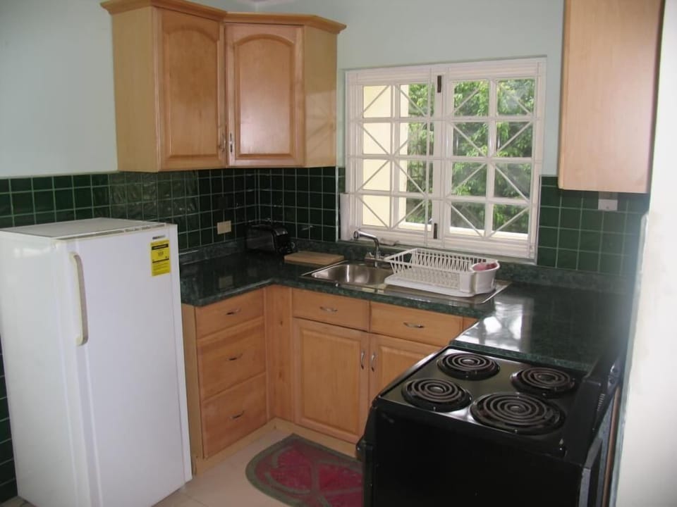 Modern fitted kitchen, complete with toaster, blender, pots and pans & cutlery.