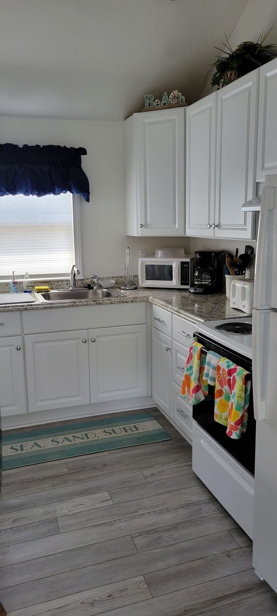 Updated kitchen new floor installed from kitchen to living room. Engineered wood