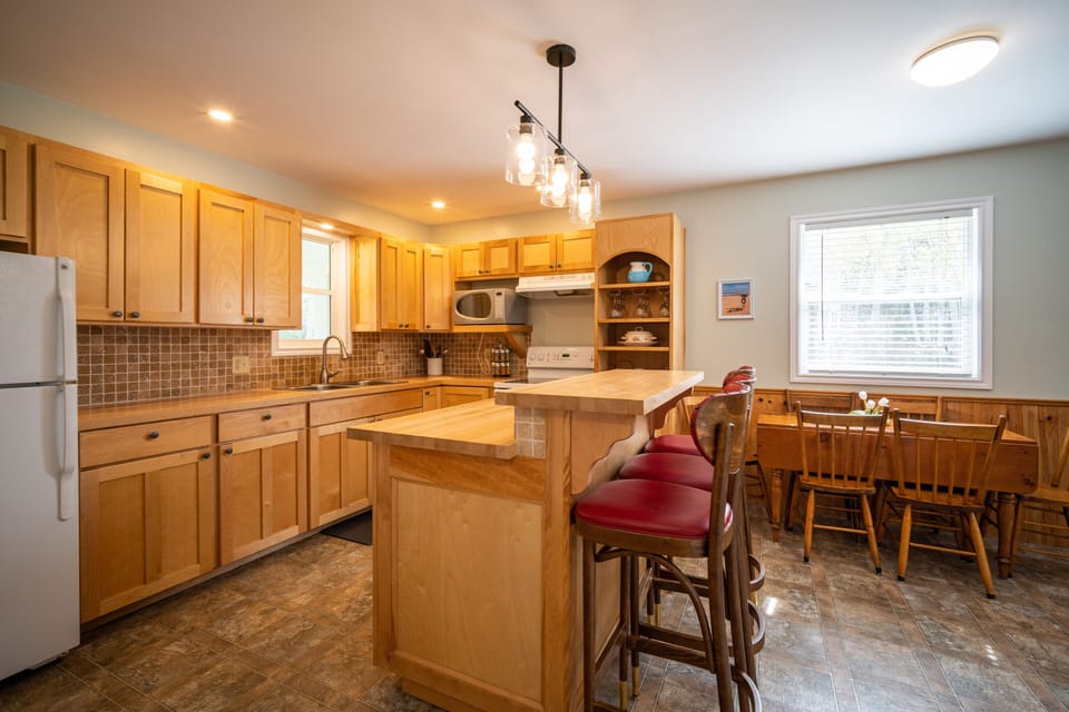 Kitchen with island eating area and table and chairs

