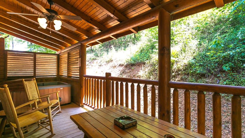 Covered Back Porch with Large Hot Tub, Sauna, Picnic Table, and Rocking Chairs