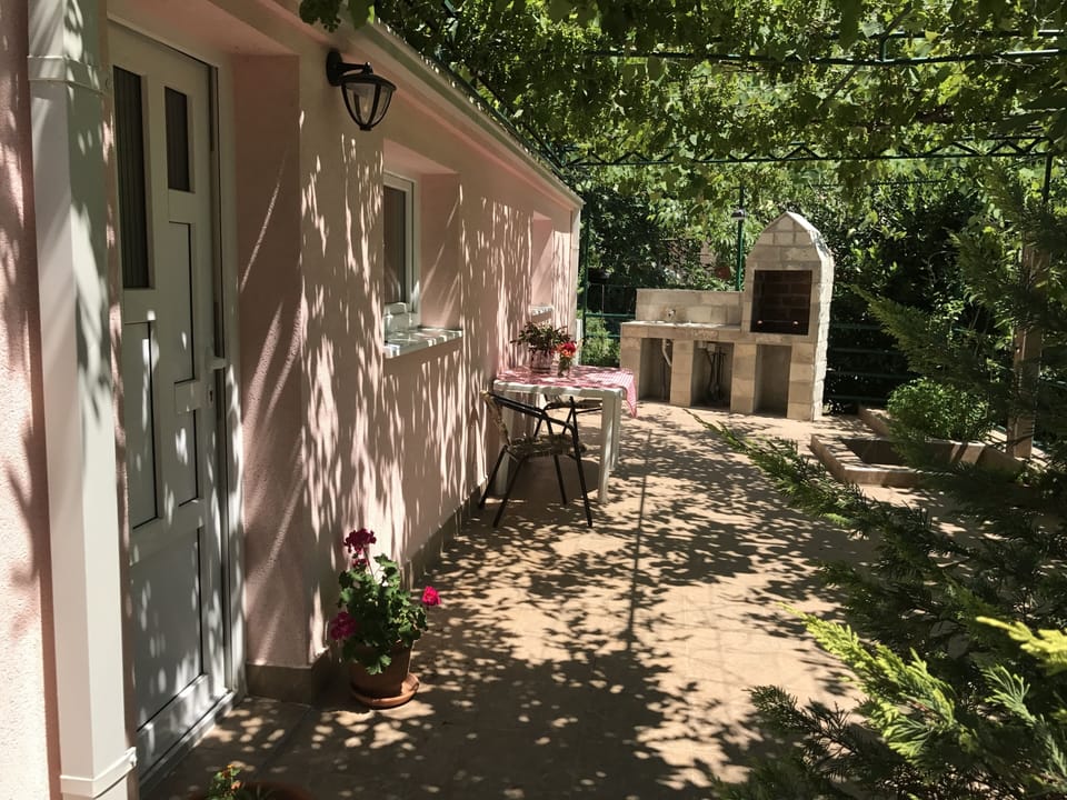 Your private sun dappled terrace with outside BBQ kitchen and shower spa