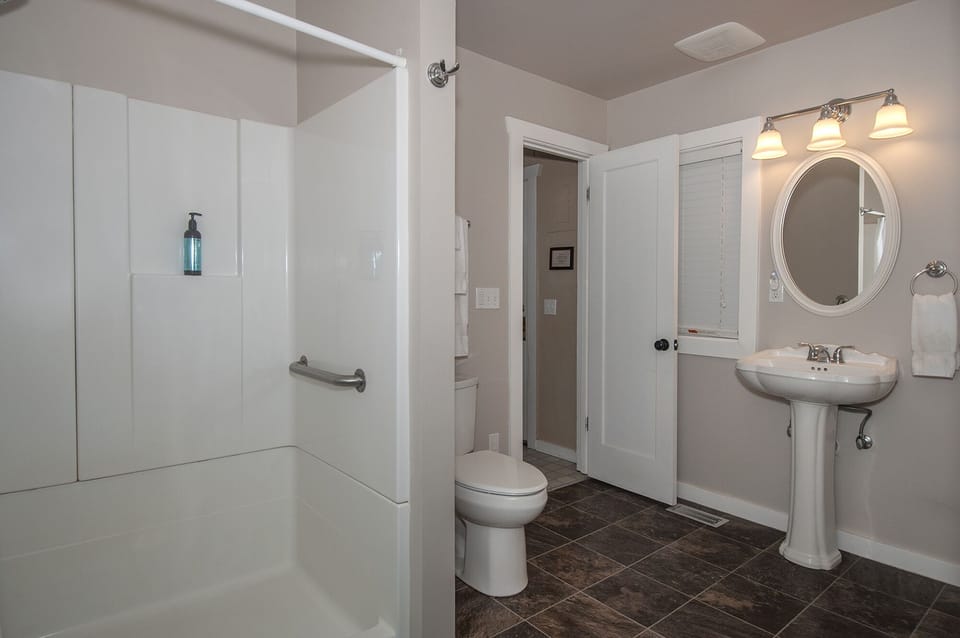 Shower/ grab bars, wide doors and low threshold shower.     