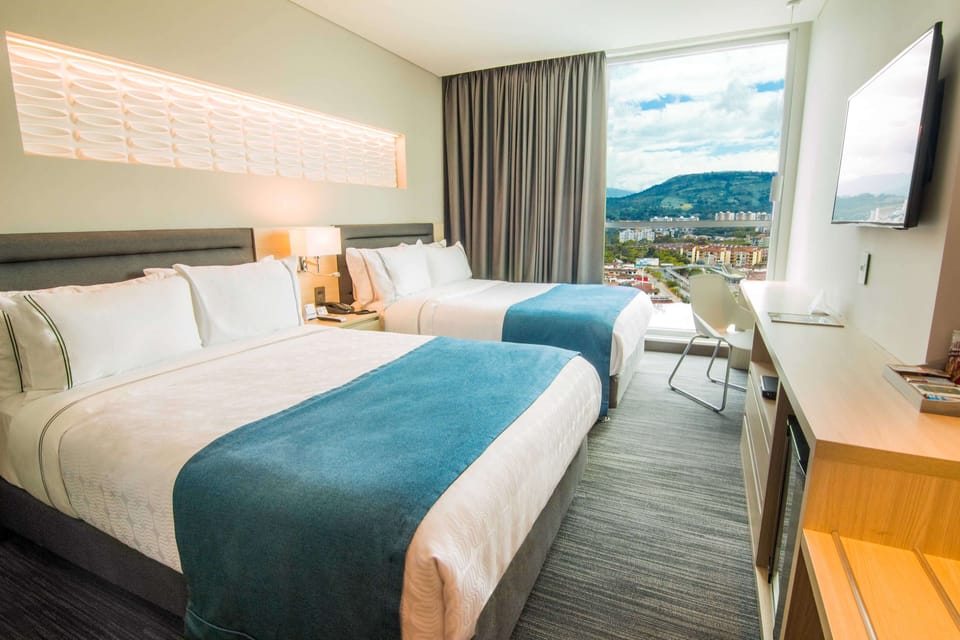 Standard Room, 2 Queen Beds | In-room safe, desk, laptop workspace, blackout drapes