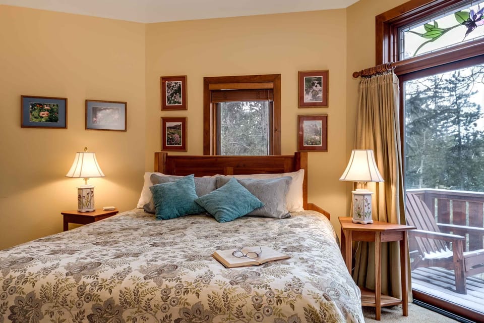 The master bedroom features a private balcony and king-sized bed.