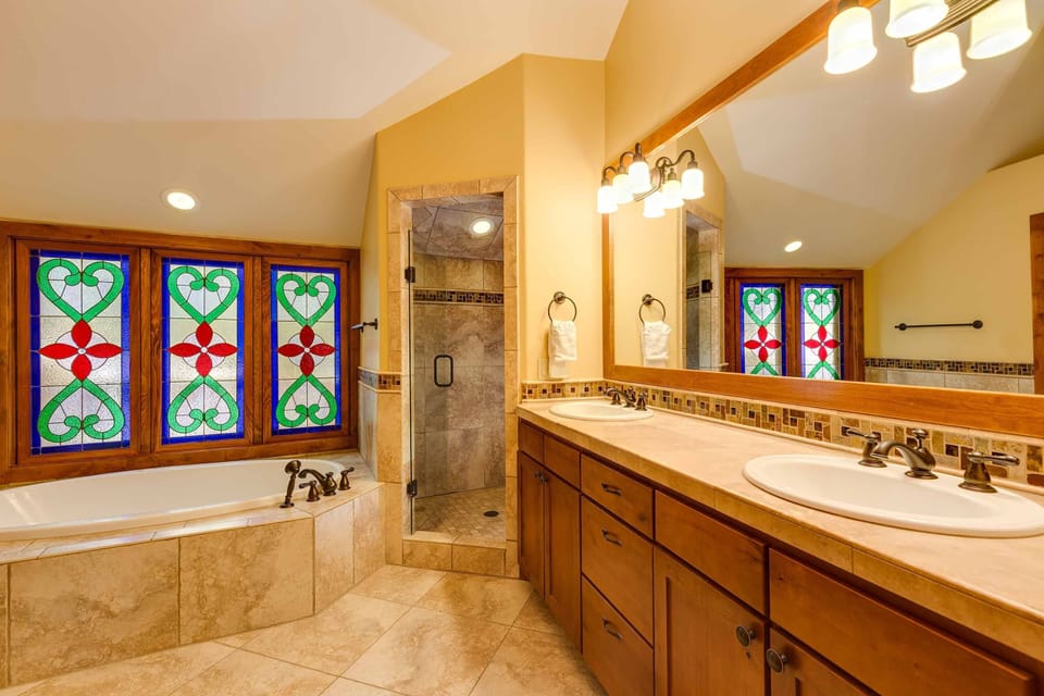 The master bath features a jetted tub, walk-in shower, and double vanity.