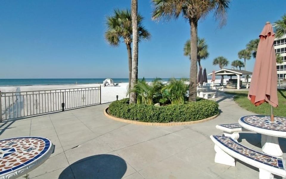 Tiki Hut and deck area.  4  barbecue grills and lots of tables and benches. 