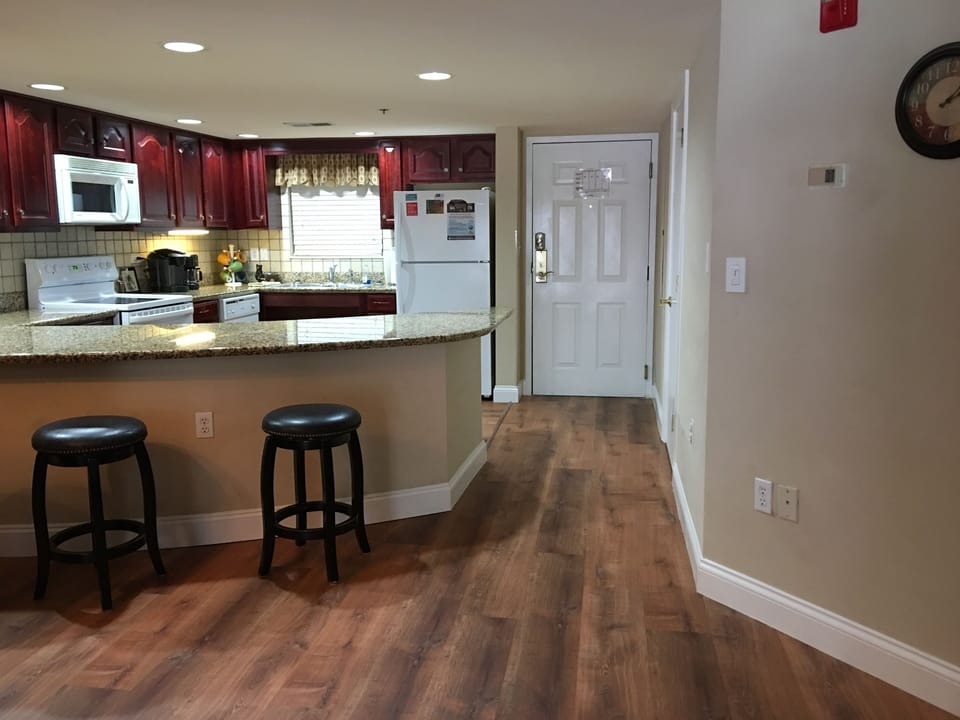 Front entry door with kitchen off to the right as you enter.