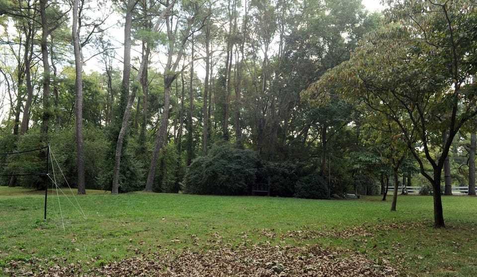 View of back property with badminton net and outdoor games  