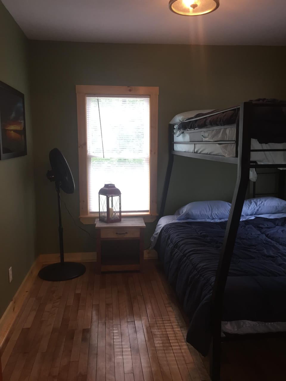 queen bottom and double on top in the bunk room with oscillating fan 