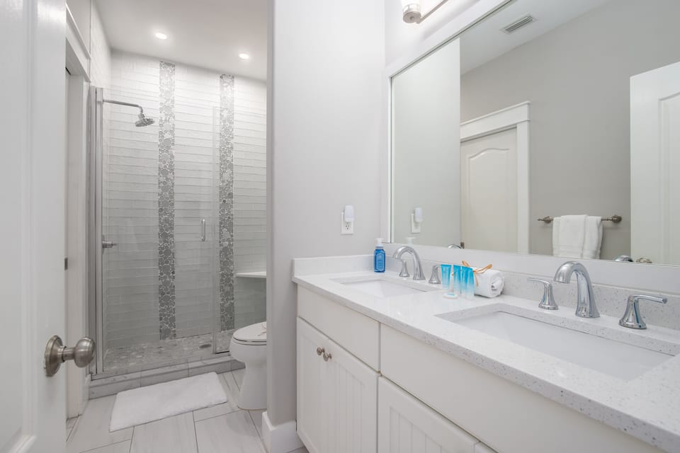 Second floor full bathroom with double vanity, and glass walk-in shower