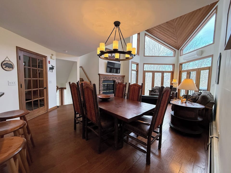 Open concept living, dining and kitchen area with Wood Burning Fireplace and TV