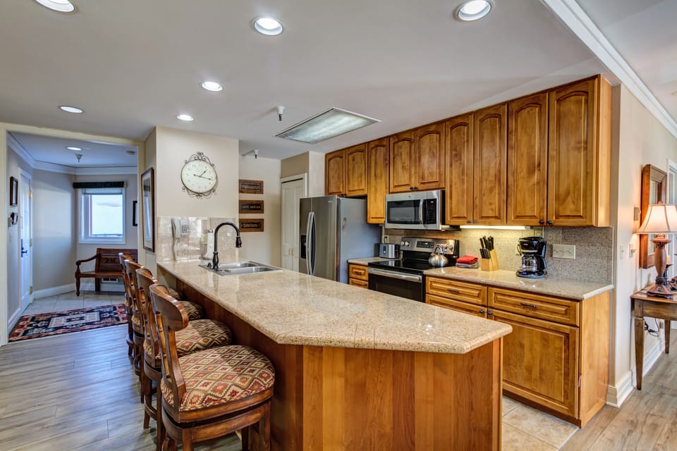 Granite counter tops, counter seating and fully stocked kitchen
