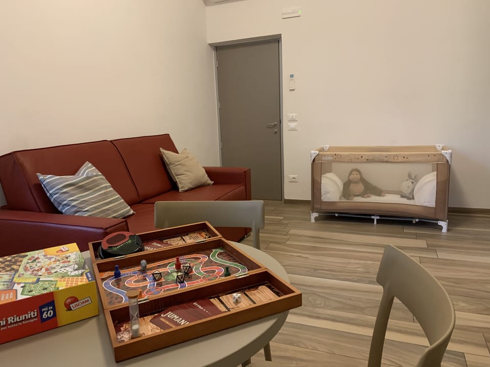 Family Quadruple Room, 1 Bedroom | Living room | 30-inch flat-screen TV with cable channels, TV