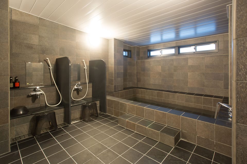 Separate tub and shower, hair dryer, slippers, towels