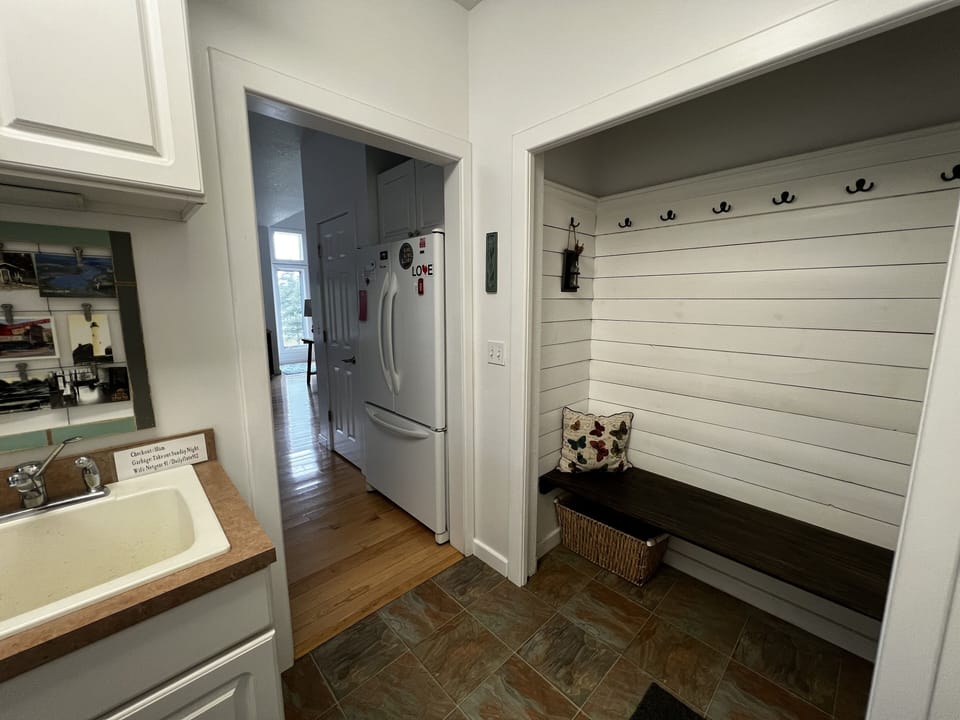 Open coat hooks, bench, storage area