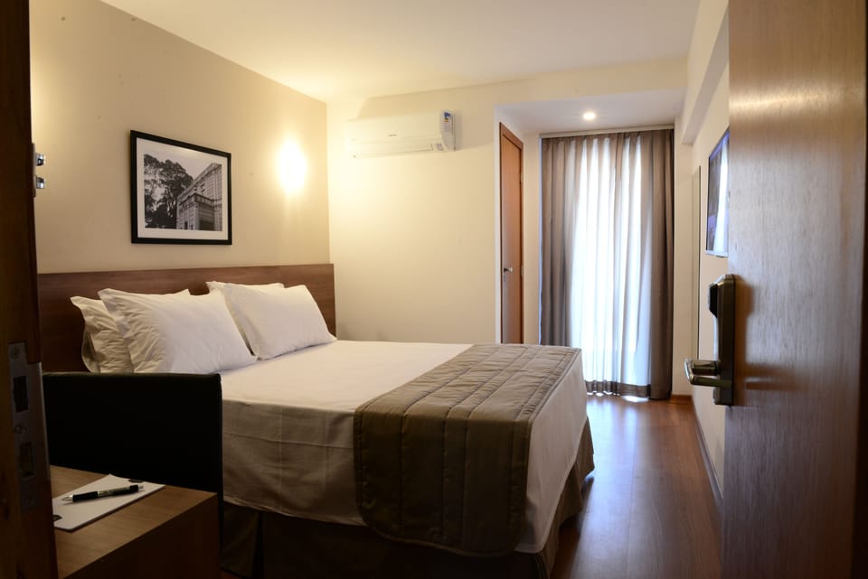 Double Room | Minibar, in-room safe, desk, blackout drapes