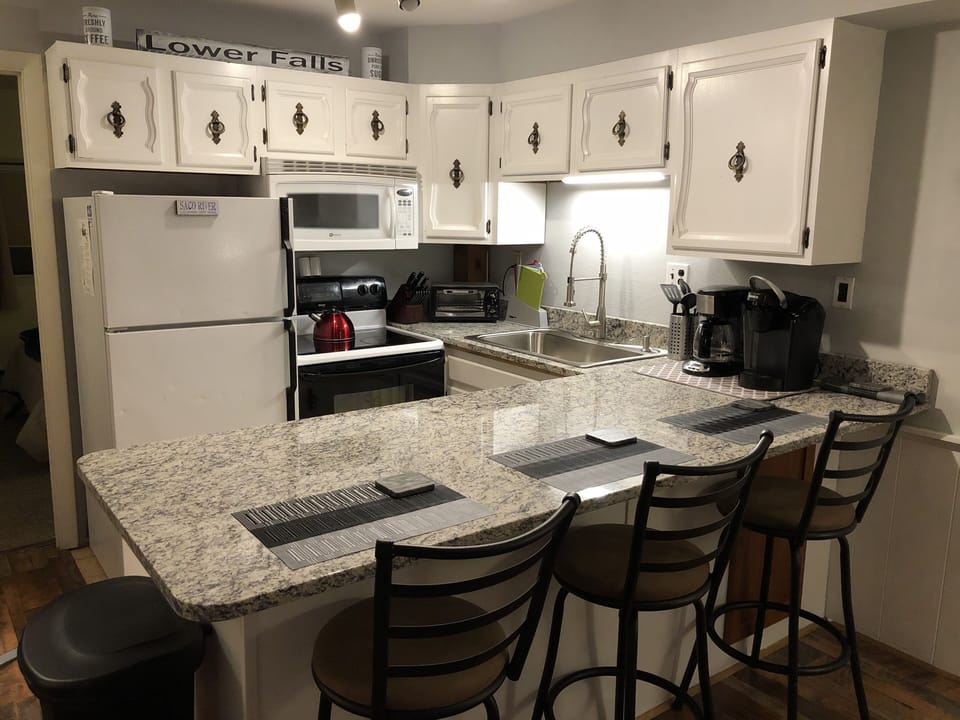 Beautiful granite countertops including huge counter top with 3 stools.