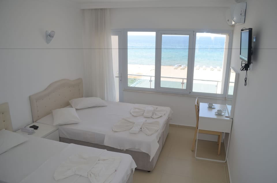 Standard Triple Room, Sea View | Premium bedding, minibar, desk, soundproofing