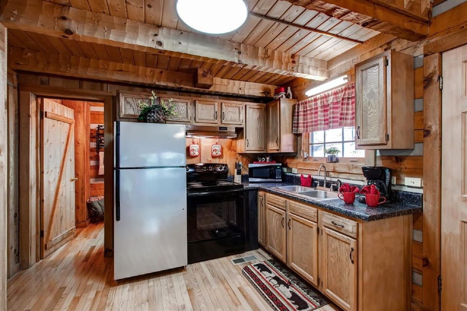 Kitchen features stainless fridge, new stove, new countertops, & open floorplan.