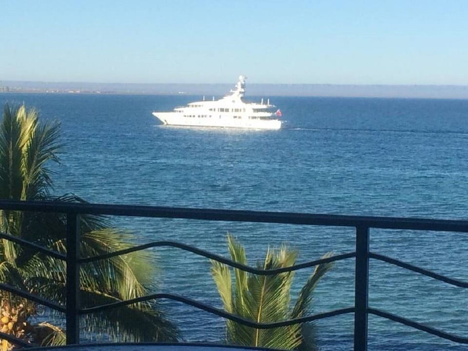 Yachts come into La Paz harbor and pass the balcony. 