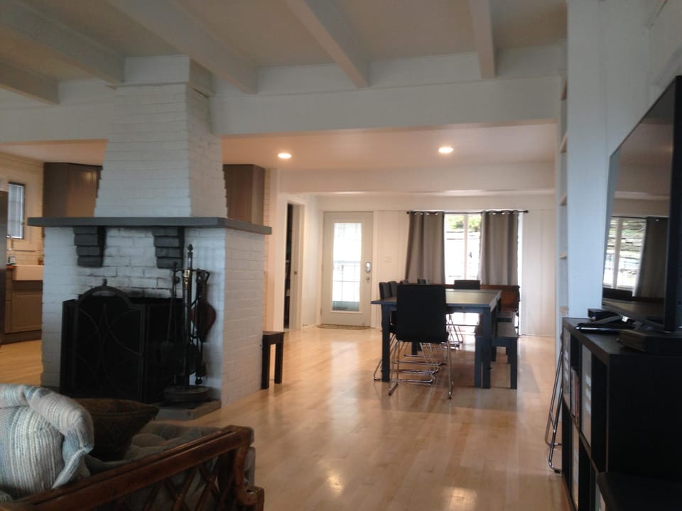 Wider View with Fireplace to left, TV to right, Dining area and part of Kitchen