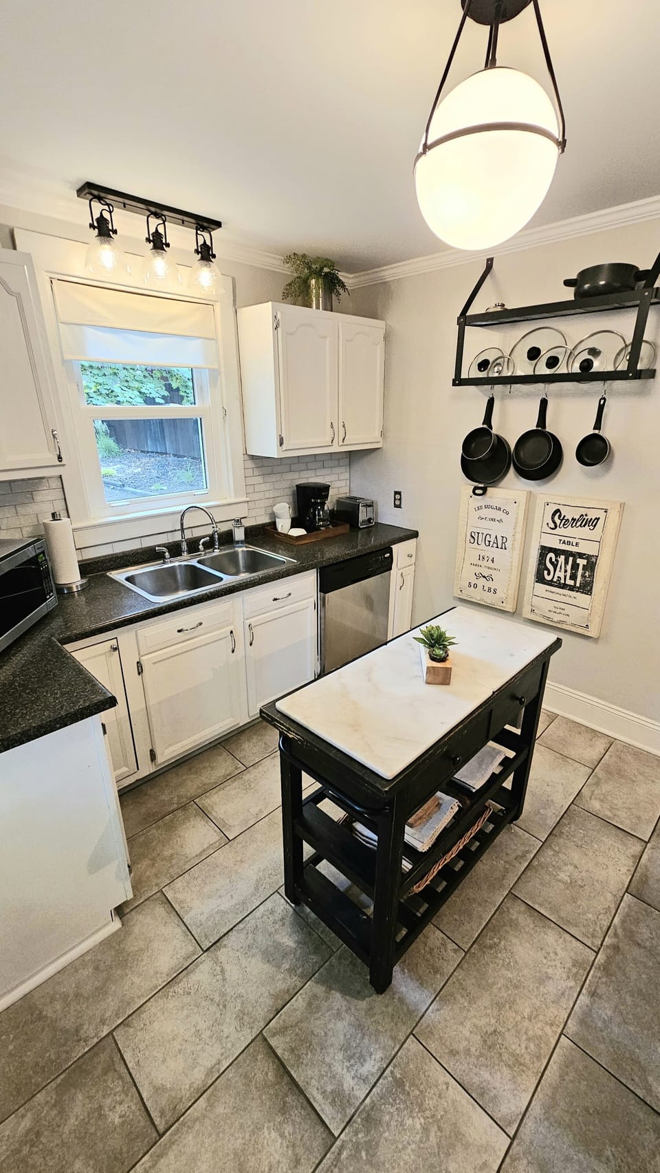 Kitchen has a dishwasher and full set of cookware