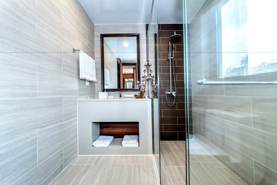 Shower, designer toiletries, hair dryer, slippers