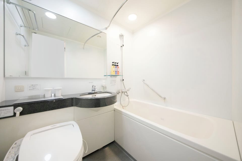 Combined shower/tub, free toiletries, hair dryer, slippers