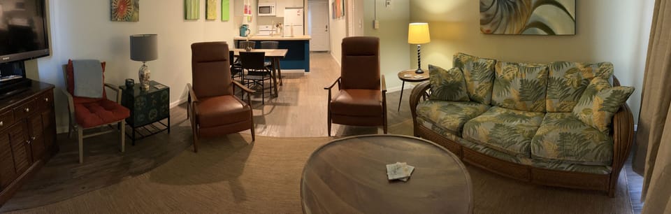 Panoramic angle view looking from balcony into main living area