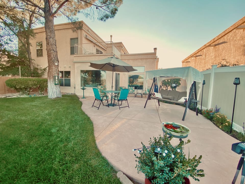 Private fenced back patio, tables, glider, bird feeders, BBQ