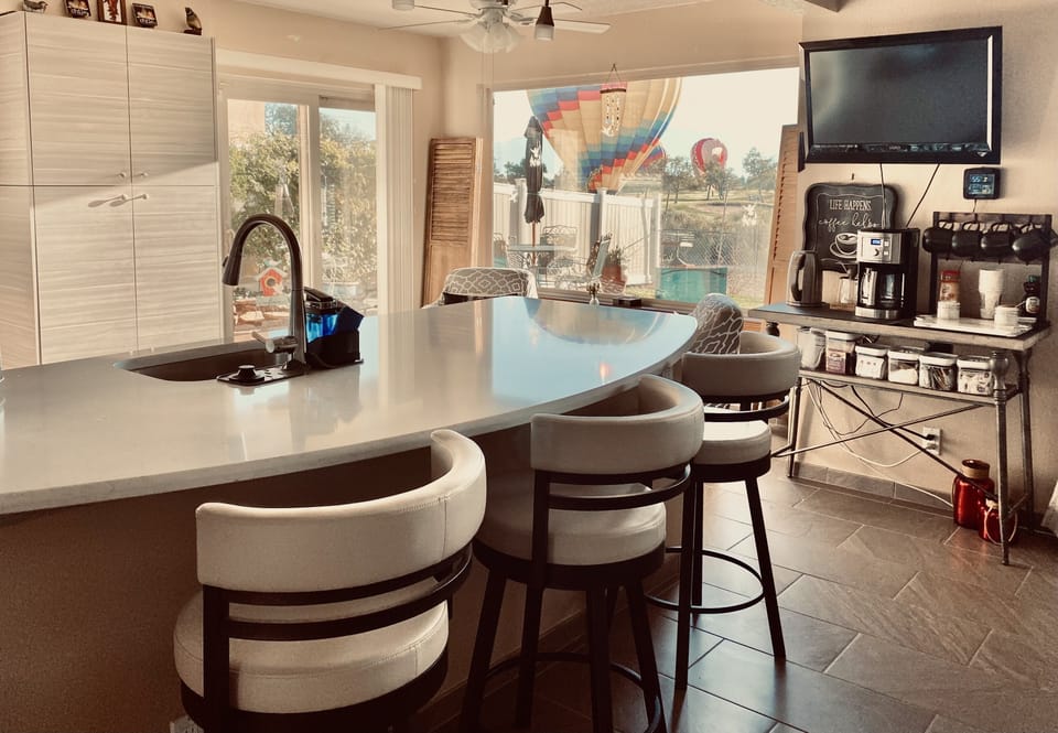 Kitchen with swivel bar stools, coffee bar