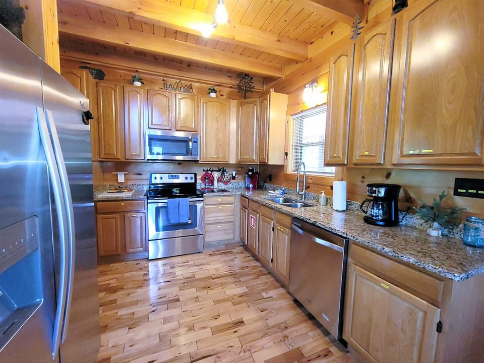 Stainless Whirlpool side by side frig w/ ice maker; glass top stove, microwave. 
