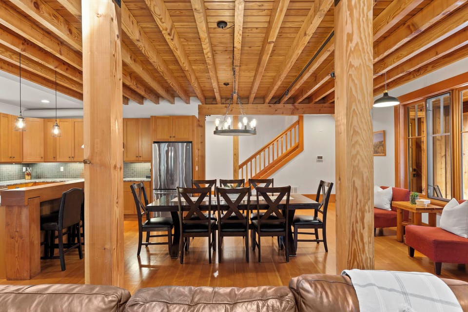 overview of dining room and kitchen.  stairs leading to upper floor