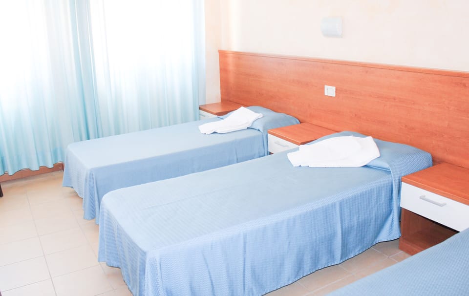 Triple Room (Beach access included) | Desk, free cribs/infant beds, bed sheets