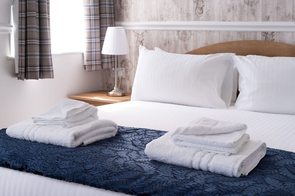 Desk, iron/ironing board, bed sheets