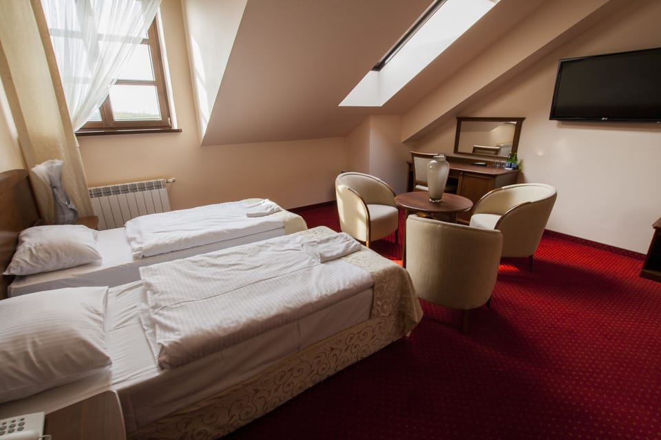 Premium bedding, desk, laptop workspace, blackout drapes
