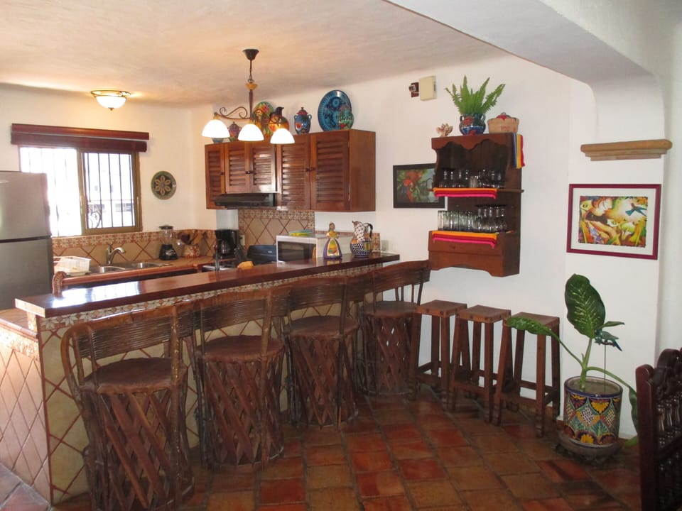 Fully equipped kitchen with large eating bar and comfortable seating. Great view