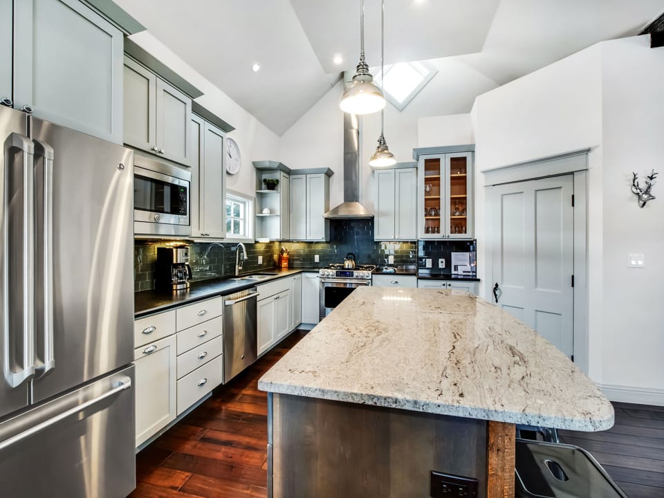 Well equipped kitchen with full dishes, pots and pans, and accessories. 