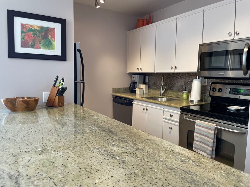 Well appointed kitchen with utensils, pots and pans.  Granite counters