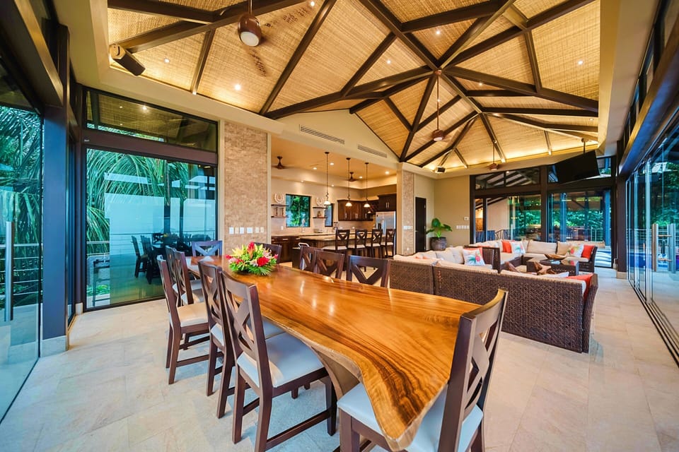 Spacious great room with open-air dining and lush jungle views ideal for groups