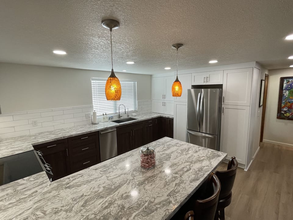 Spacious modern kitchen with counter seating.