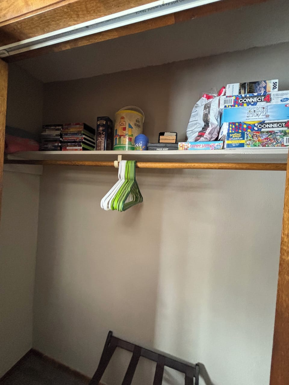 Bunk room closet with games, books, movies, and puzzles.