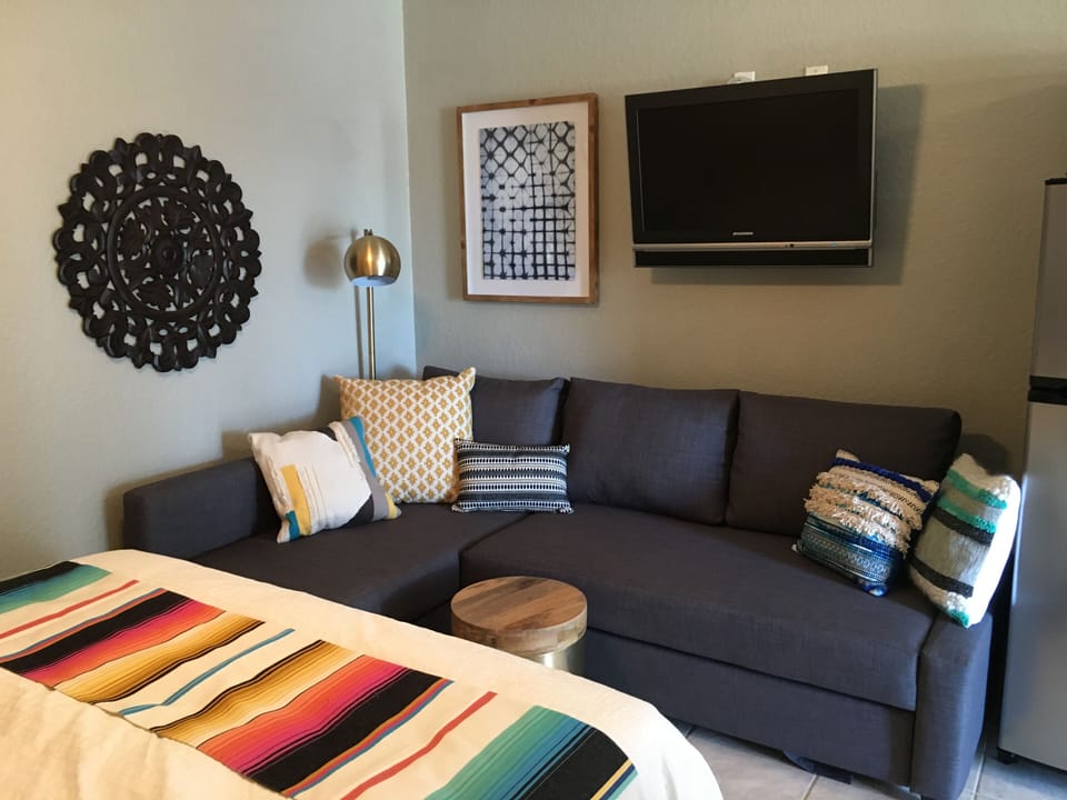 Living room area with queen size sleeper sofa and cable TV.