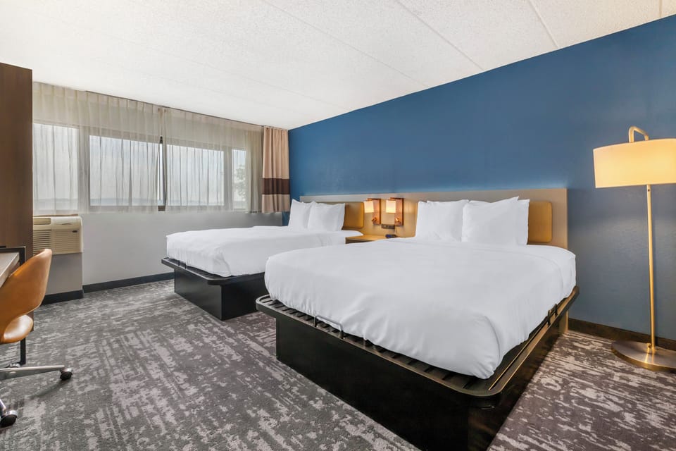 Premium bedding, desk, laptop workspace, blackout drapes