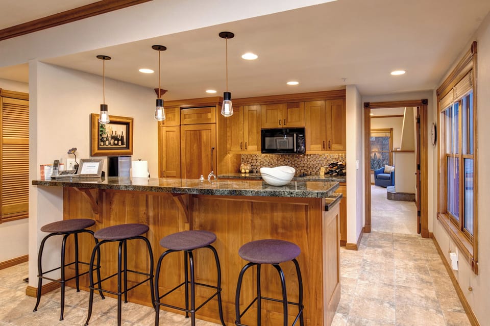 Bar looking into kitchen. Great gathering while pouring refreshments!