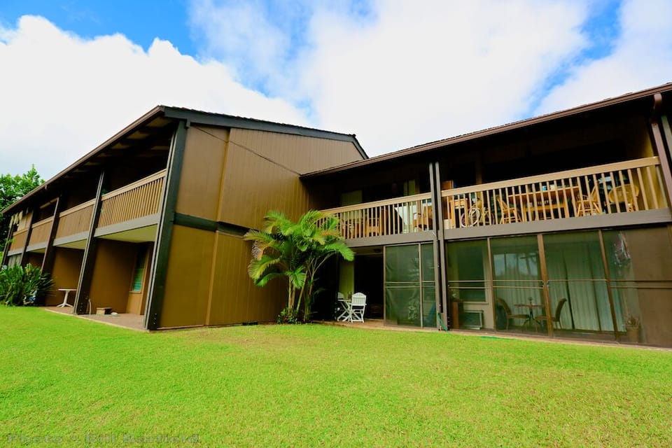 Rear View Of Condo w/White Chair On Lanai