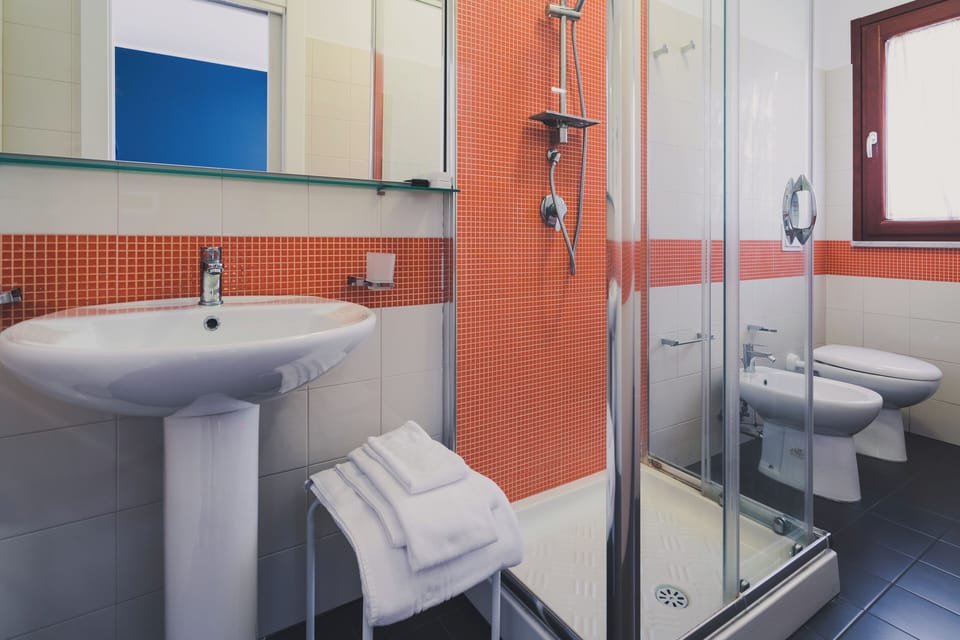 Comfort Double Room Single Use, Accessible, Balcony | Bathroom | Shower, free toiletries, hair dryer, slippers