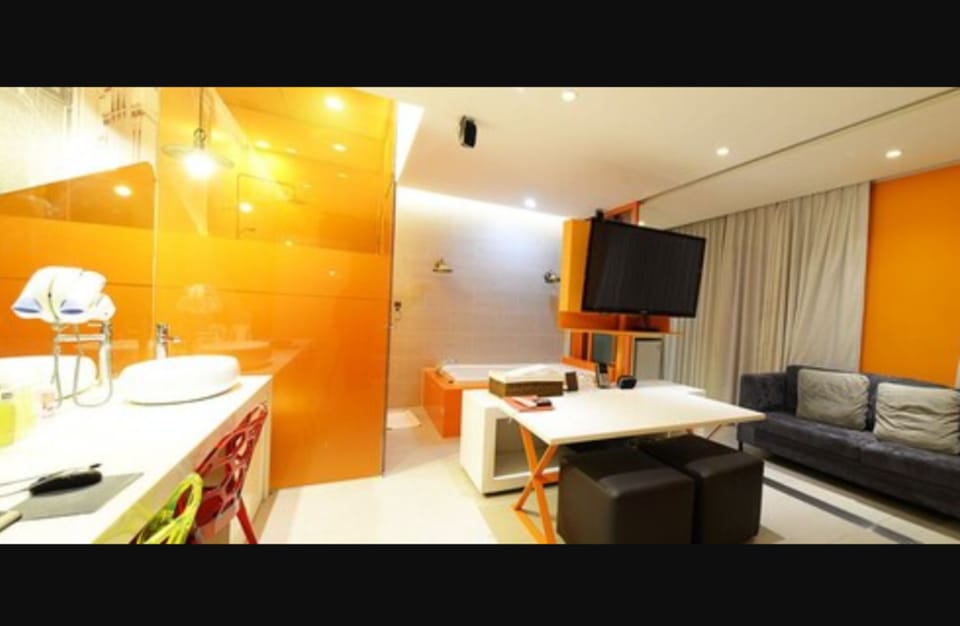 Suite (mixed gender of adults not allowed) | Living area | 55-inch flat-screen TV with cable channels, TV, heated floors